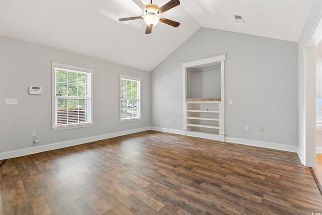 spare room featuring ceiling fan, lofted ceiling, dark wood finished floors, and baseboards