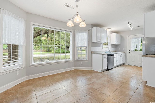 kitchen featuring appliances with stainless steel finishes, light tile patterned flooring, white cabinets, and light countertops