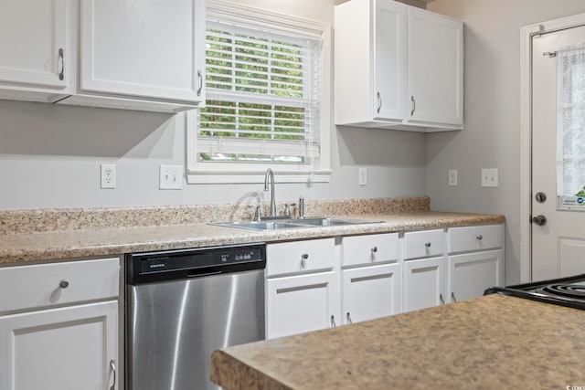kitchen with stainless steel dishwasher, a sink, light countertops, and white cabinetry
