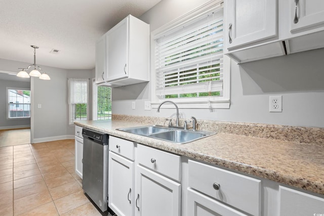 kitchen featuring a sink, stainless steel dishwasher, white cabinetry, light countertops, and a textured ceiling