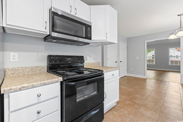 kitchen with electric range, stainless steel microwave, light countertops, white cabinetry, and a textured ceiling