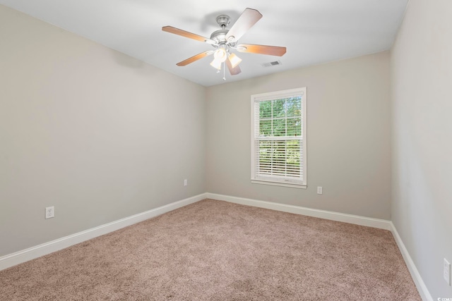 empty room featuring carpet, baseboards, and ceiling fan