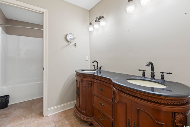 full bathroom featuring double vanity, bathtub / shower combination, tile patterned flooring, and baseboards