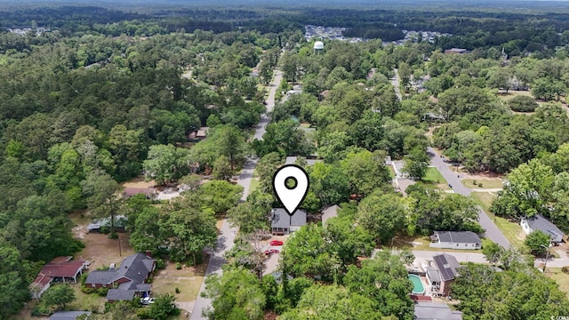 aerial view of property's location with a forest