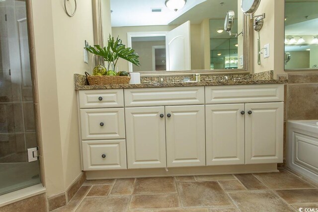 100 N Beach Blvd Unit 1902, North Myrtle Beach, SC 29582 - bathroom with vanity, a shower stall, stone finish flooring, and a bathtub