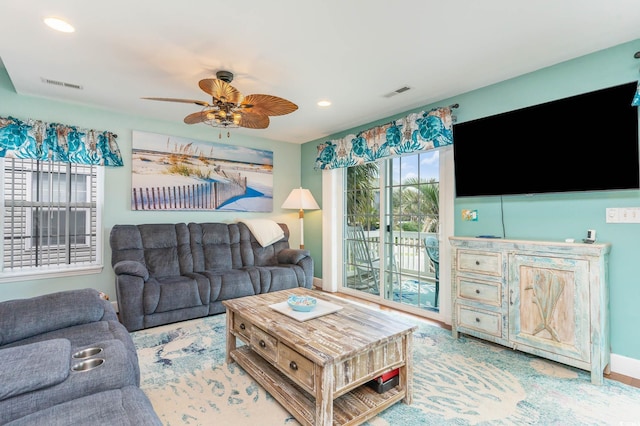 living room with recessed lighting, a ceiling fan, and baseboards