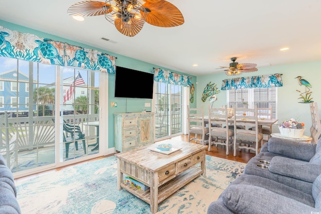 living area featuring a ceiling fan, wood finished floors, and recessed lighting