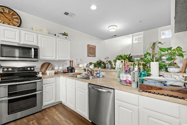 160 Cart Crossing Dr Unit 104, Conway, SC 29526 - kitchen featuring appliances with stainless steel finishes, a sink, light countertops, dark wood finished floors, and white cabinets