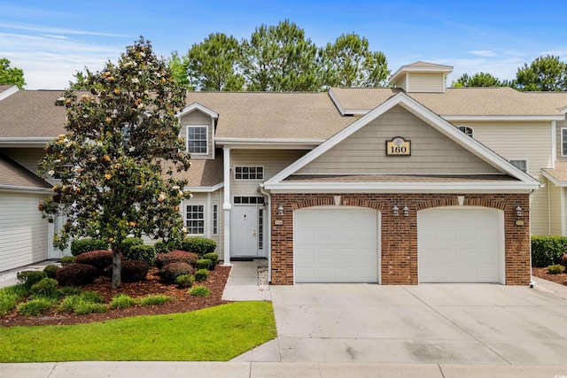 160 Cart Crossing Dr Unit 104, Conway, SC 29526 - view of front facade featuring concrete driveway, a garage, brick siding, and a shingled roof