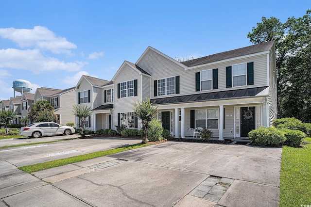 1196 Harvester Cir Unit 1196, Myrtle Beach, SC 29579 - view of front of property featuring a standing seam roof, metal roof, covered porch, and a residential view