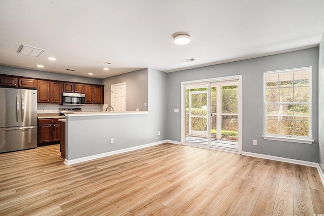 1196 Harvester Cir Unit 1196, Myrtle Beach, SC 29579 - kitchen with stainless steel appliances, light countertops, baseboards, light wood-type flooring, and recessed lighting