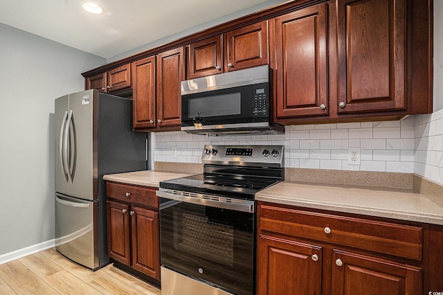 1196 Harvester Cir Unit 1196, Myrtle Beach, SC 29579 - kitchen with stainless steel appliances, light wood-type flooring, backsplash, light countertops, and baseboards