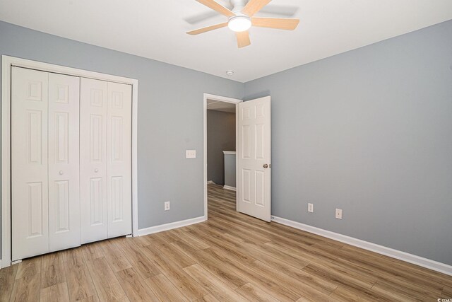 1196 Harvester Cir Unit 1196, Myrtle Beach, SC 29579 - unfurnished bedroom with light wood-style flooring, baseboards, and a closet