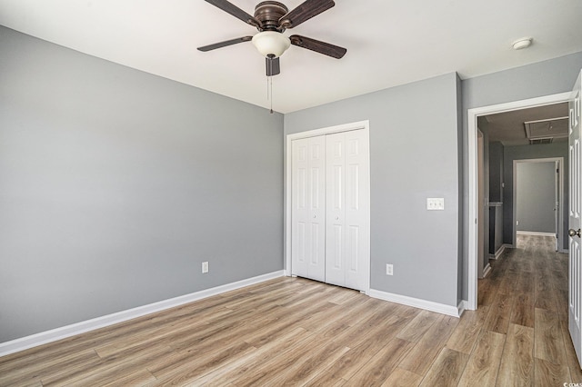 1196 Harvester Cir Unit 1196, Myrtle Beach, SC 29579 - unfurnished bedroom featuring light wood-style floors, attic access, a closet, baseboards, and a ceiling fan