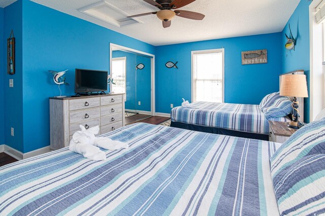 163 Cypress Ave, Murrells Inlet, SC 29576 - bedroom featuring a textured ceiling, baseboards, attic access, ceiling fan, and wood finished floors