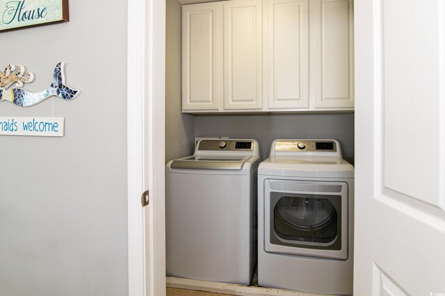 163 Cypress Ave, Murrells Inlet, SC 29576 - washroom featuring separate washer and dryer and cabinet space