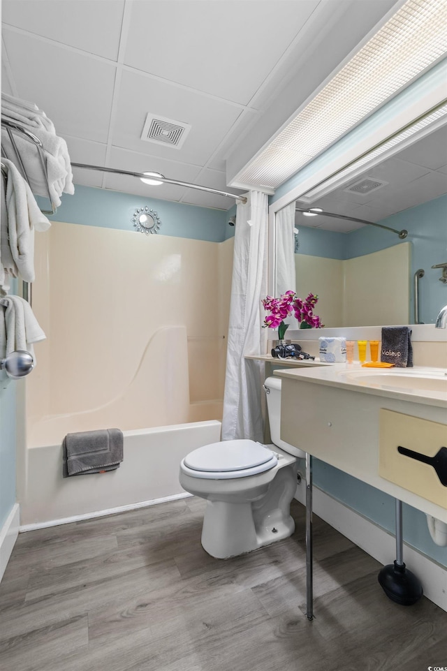 202 74th Ave N Unit 2547/2548, Myrtle Beach, SC 29572 - bathroom with shower / bath combo with shower curtain, toilet, wood finished floors, vanity, and baseboards