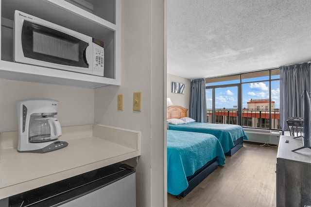 202 74th Ave N Unit 2547/2548, Myrtle Beach, SC 29572 - bedroom featuring wood finished floors and a textured ceiling