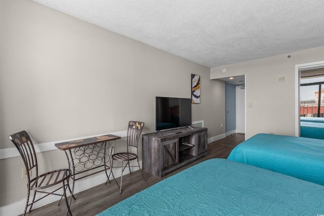 202 74th Ave N Unit 2547/2548, Myrtle Beach, SC 29572 - bedroom with wood finished floors, a textured ceiling, and baseboards
