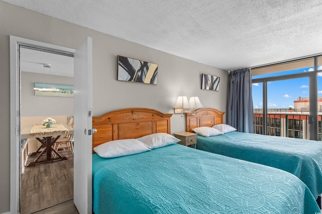 202 74th Ave N Unit 2547/2548, Myrtle Beach, SC 29572 - bedroom featuring wood finished floors, a textured ceiling, and access to exterior