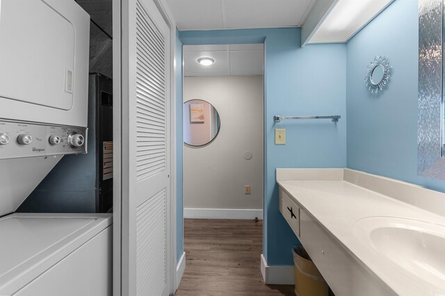 202 74th Ave N Unit 2547/2548, Myrtle Beach, SC 29572 - clothes washing area featuring stacked washer and clothes dryer, wood finished floors, and baseboards