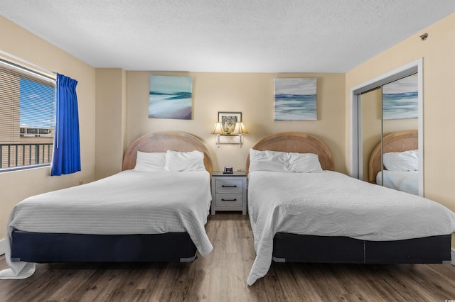 202 74th Ave N Unit 2547/2548, Myrtle Beach, SC 29572 - bedroom with a textured ceiling and wood finished floors