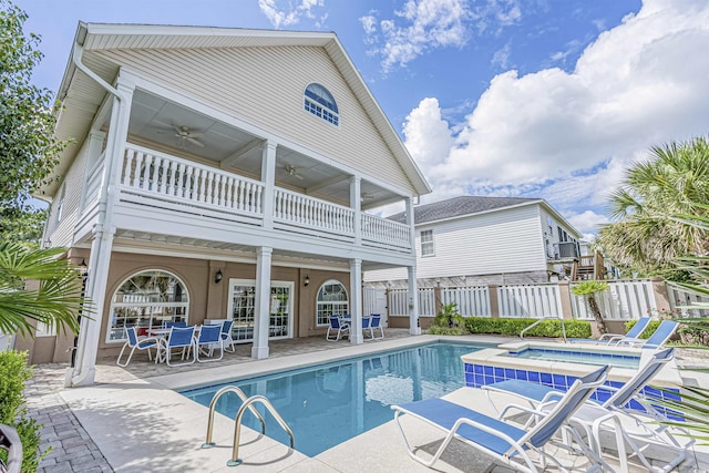 500 23rd Ave S, North Myrtle Beach, SC 29582 - rear view of property with a ceiling fan, a balcony, a patio area, outdoor dining space, and a pool with connected hot tub
