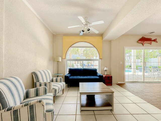 500 23rd Ave S, North Myrtle Beach, SC 29582 - tiled living room featuring plenty of natural light, a textured ceiling, a ceiling fan, and a textured wall