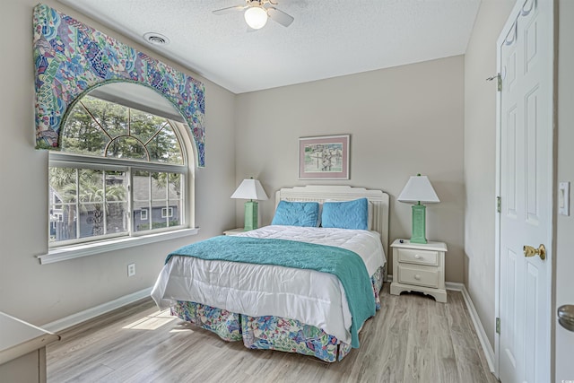 500 23rd Ave S, North Myrtle Beach, SC 29582 - bedroom with wood finished floors, baseboards, a textured ceiling, and a ceiling fan
