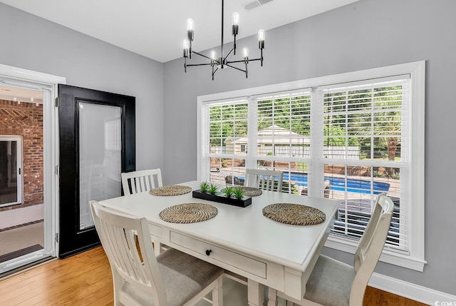 dining room with a chandelier and light wood-style floors
