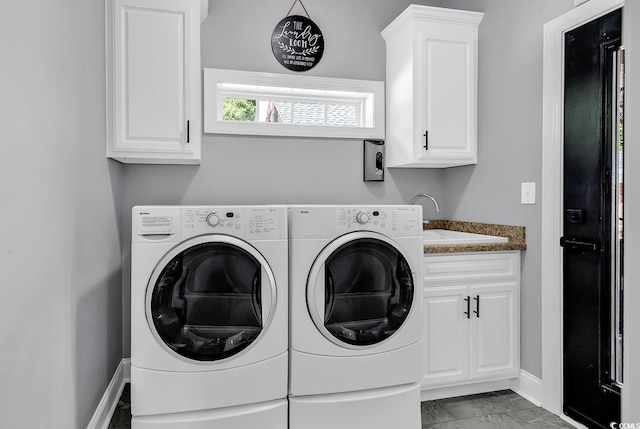 washroom with cabinet space, independent washer and dryer, baseboards, and marble look tile flooring