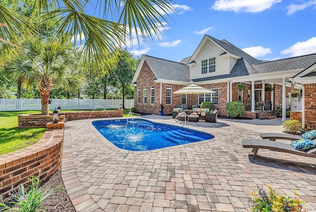 view of pool featuring a fenced backyard, a patio, and outdoor lounge area