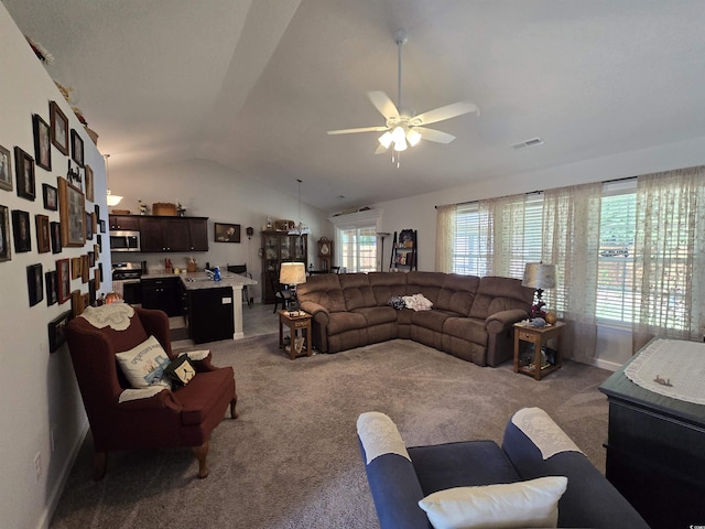 carpeted living area with vaulted ceiling, ceiling fan, baseboards, and a sink