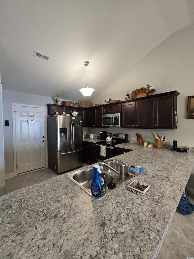 kitchen with stainless steel appliances, lofted ceiling, dark brown cabinetry, a sink, and a peninsula