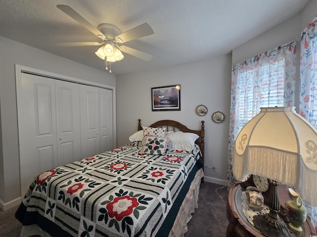 carpeted bedroom featuring a closet, baseboards, and ceiling fan