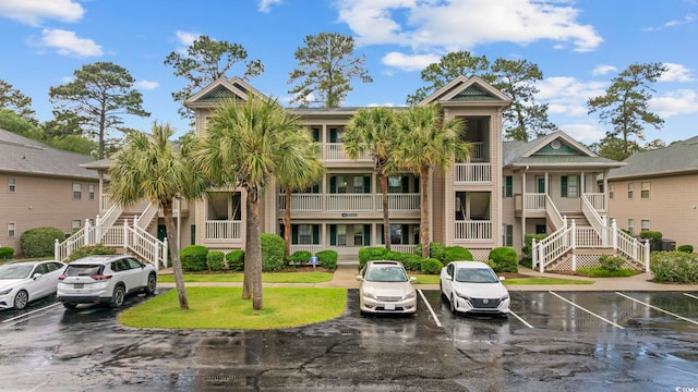 69 Pinehurst Ln Unit 3-F, Pawleys Island, SC 29585 - view of property with stairway and uncovered parking