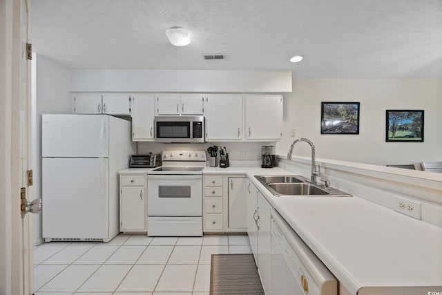 69 Pinehurst Ln Unit 3-F, Pawleys Island, SC 29585 - kitchen featuring white appliances, a sink, light countertops, light tile patterned floors, and white cabinetry