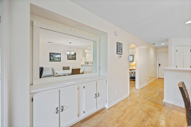 69 Pinehurst Ln Unit 3-F, Pawleys Island, SC 29585 - hall with light wood-type flooring, a chandelier, baseboards, and recessed lighting