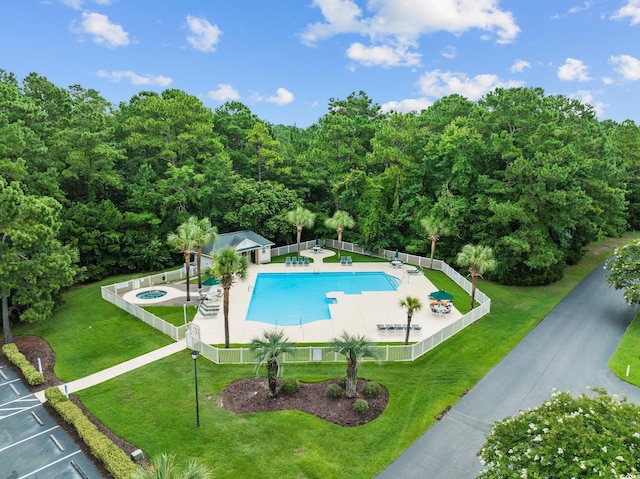 69 Pinehurst Ln Unit 3-F, Pawleys Island, SC 29585 - community pool with a patio, a hot tub, a wooded view, and an outbuilding