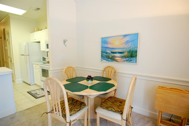 400 Lands End Blvd Unit 5304, Myrtle Beach, SC 29572 - dining room featuring wainscoting, light tile patterned floors, and light carpet