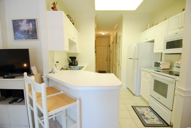 400 Lands End Blvd Unit 5304, Myrtle Beach, SC 29572 - kitchen with white appliances, a sink, a breakfast bar, a peninsula, and light tile patterned floors