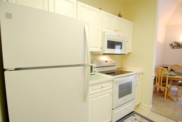 400 Lands End Blvd Unit 5304, Myrtle Beach, SC 29572 - kitchen featuring white appliances, light tile patterned flooring, white cabinetry, light countertops, and light colored carpet