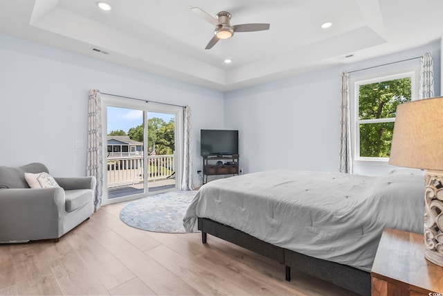 400 Elizabeth Dr, Murrells Inlet, SC 29576 - bedroom featuring a raised ceiling, multiple windows, access to outside, light wood finished floors, and recessed lighting