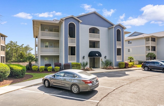 4520 Coquina Harbour Dr Unit F-3, Little River, SC 29566 - view of building exterior with uncovered parking
