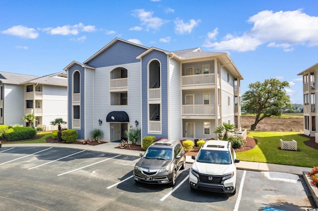 4520 Coquina Harbour Dr Unit F-3, Little River, SC 29566 - view of property featuring uncovered parking
