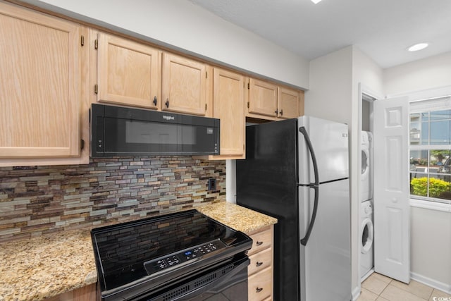 4520 Coquina Harbour Dr Unit F-3, Little River, SC 29566 - kitchen featuring black appliances, light brown cabinets, stacked washer / dryer, light stone counters, and recessed lighting