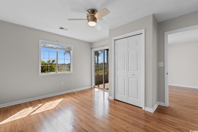 4520 Coquina Harbour Dr Unit F-3, Little River, SC 29566 - unfurnished bedroom featuring light wood-style flooring, access to outside, a ceiling fan, and a closet