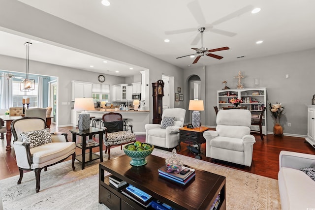 living area featuring recessed lighting, light wood-style floors, plenty of natural light, ceiling fan, and baseboards