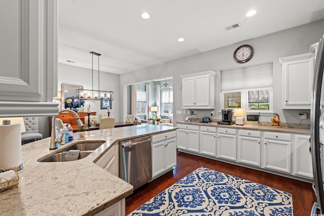 kitchen with a sink, dishwasher, plenty of natural light, white cabinetry, and recessed lighting