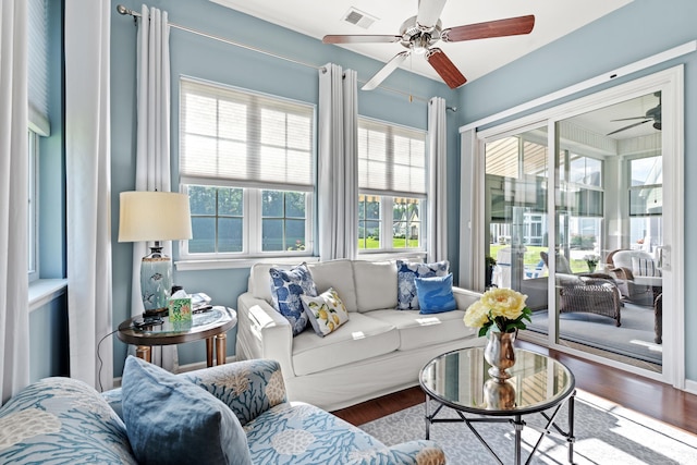 living area with ceiling fan and wood finished floors